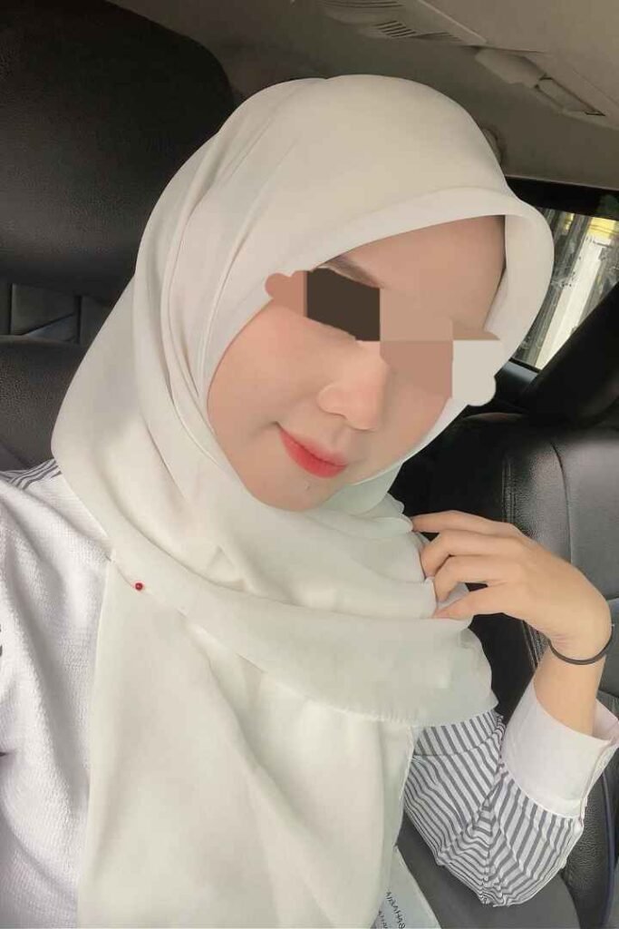 Eika, a stunning Malay Call Girl in KL, wearing a white hijab. Malaysia Escort services available.