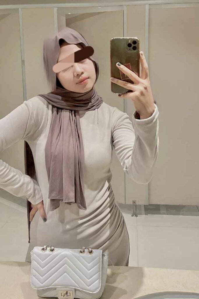 Malay woman with hijab in dress taking selfie. KL Escort, Malaysia Escort, Call Girl